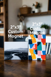 Two 2x3 custom magnets on a table with a blurred background