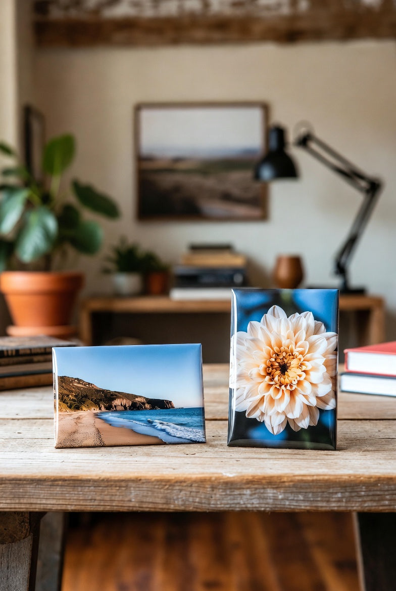 Two custom rectangle photo magnets on a wooden surface with a blurred indoor background