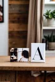 Two decorative custom 2"x3" magnets on a wooden surface with a blurred indoor background