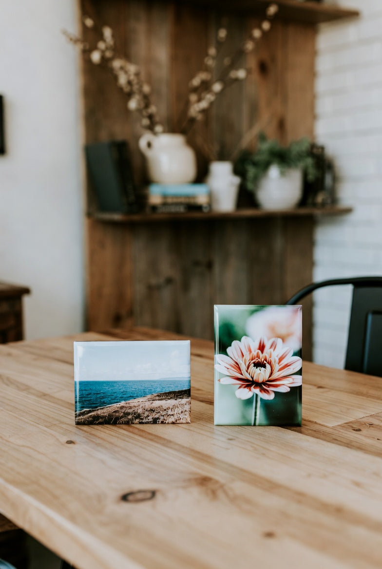 Two custom magnets on a wooden table with a blurred background of a room.