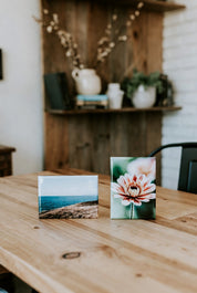 Two custom magnets on a wooden table with a blurred background of a room.