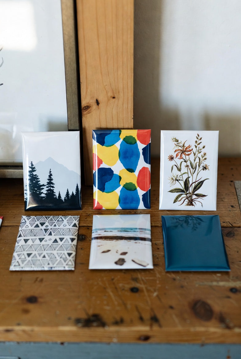 A pack of 6 rectangle custom photo magnets on a wooden surface