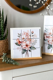 Floral Custom Puzzle Magnet Set 3x3 on a wooden shelf with decorative plants and a mirror.