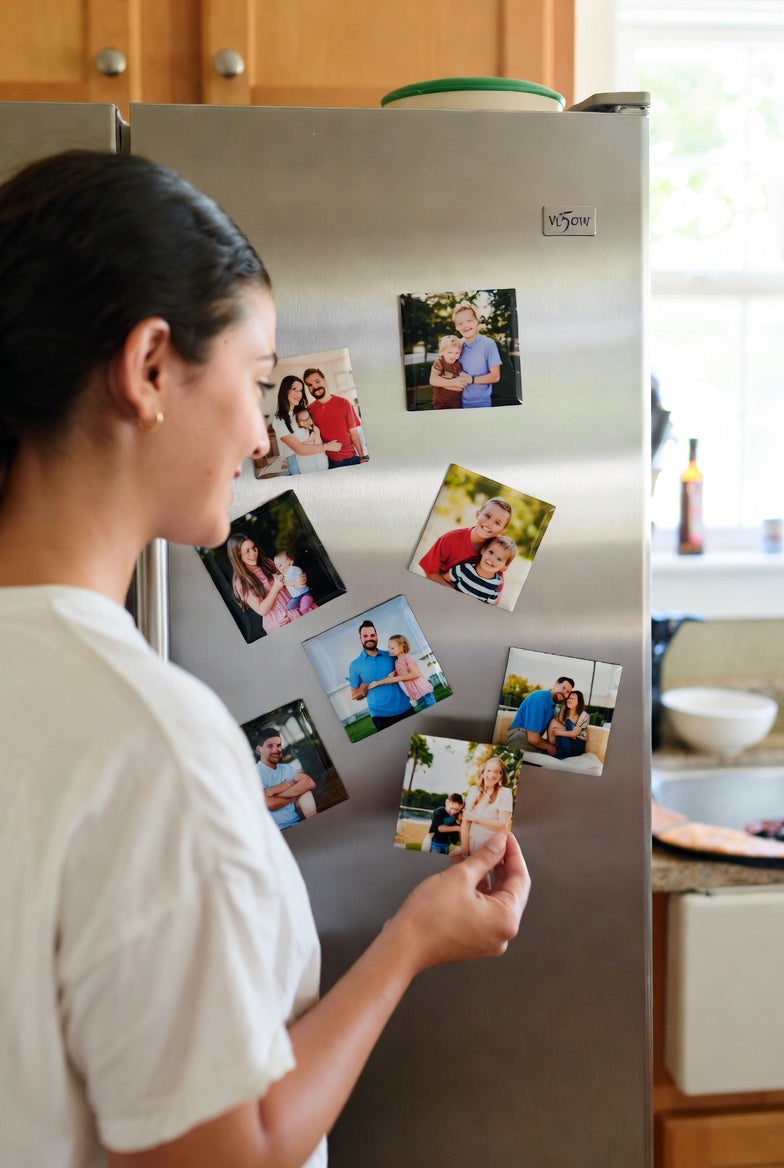Woman looking at family photos on a refrigerator door